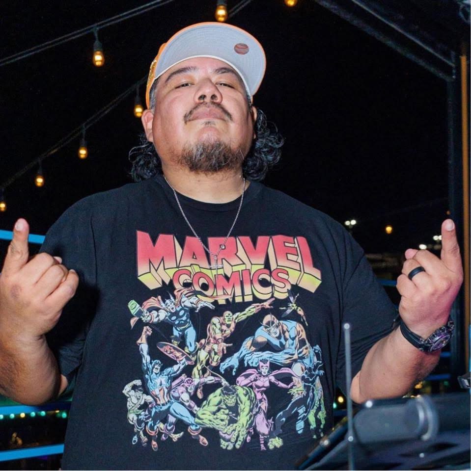 DJ John Styles at outdoor event under string lights
